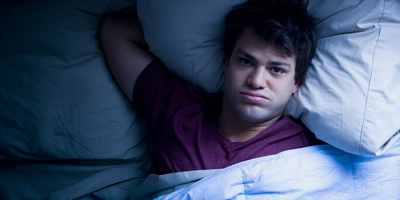 Man lying awake in bed