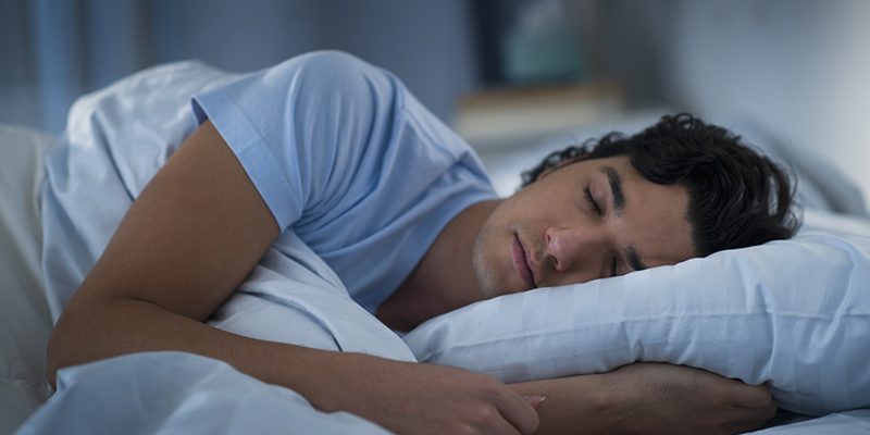 USA, New Jersey, Jersey City, Man sleeping in bed